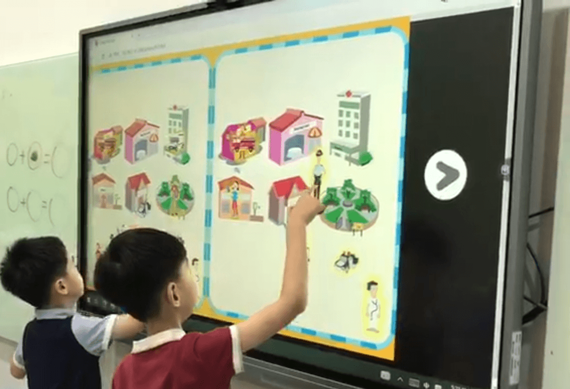 students using the interactive activities on an interactive whiteboard